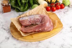 Uncooked raw pork tenderloin with spices photo