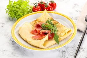 Russian pancake with salmon fish photo