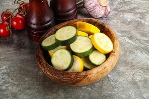 Sliced raw young green and yellow zucchini photo