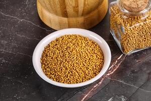 Mustard dry seeds in the bowl photo