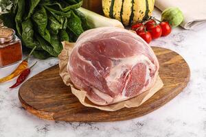 Uncooked raw pork knuckle with spices photo