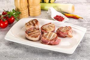 Grilled pork tenderloin with bacon photo