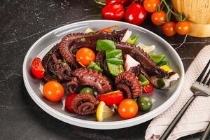 Salad with octopus tentacle and vegetables photo