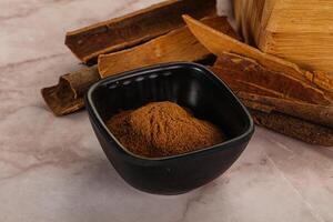 Natural Cinnamon powder with sticks photo