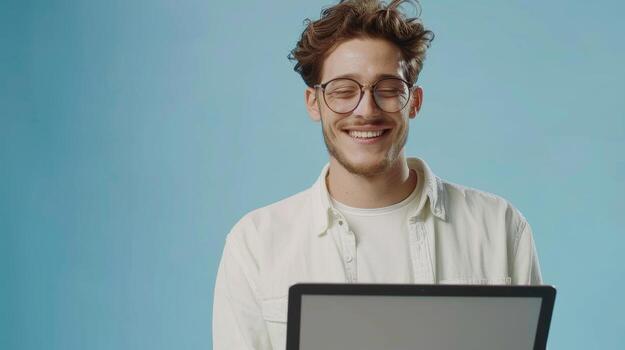 AI Generated Millennial in glasses working online or communicating on laptop computer in blue studio background photo