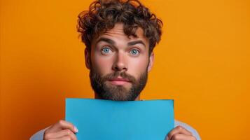 AI generated Curious man holding blue paper over face on orange background photo