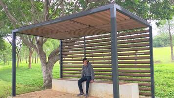 Man sitting and waiting on the shelter mini bus.  The footage is suitable to use for daily activity, transportation and travel content media. video