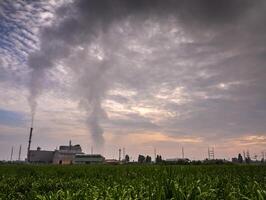 Smoke from the boiler stack and the vapor from a cooling tower in the power plant photo