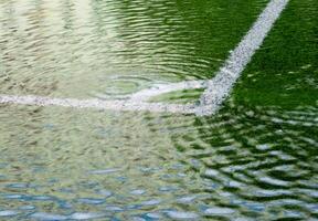 Flooding in artificial grass football field. After heavy rain photo