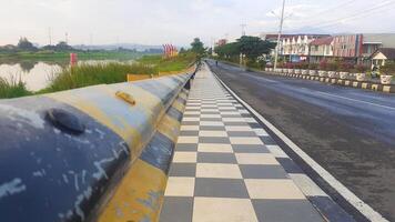 sidewalks on the edge of the road with iron guards photo