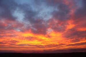 A red sky behind clouds. amazing sunset photo