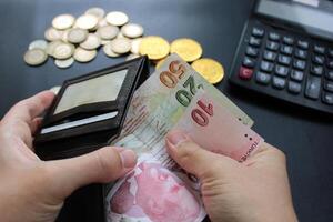 Man hand holding Turkish money wallet close up. Poverty, cost control expenses, spent too much, not enough cash, lost money concept idea. photo