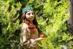 Armenian young woman in traditional clothes in the nature in summer photo