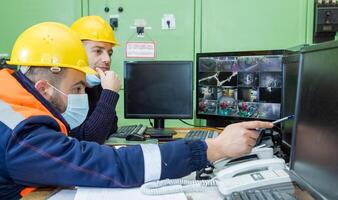 industrial workers at the work in factory photo