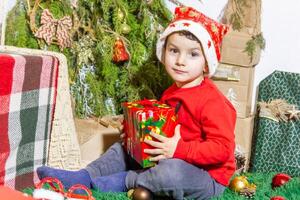 el pequeño niño jugando con Navidad decoraciones en estudio, pequeño niño con Navidad pelota foto