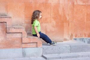 happy little boy playing in the park, long hair boy in the park photo