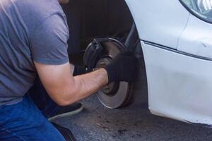 mechanic changing car wheel, car mechanic changing the wheel of a car photo