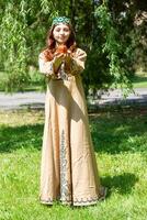 Armenian young woman in traditional clothes in the nature in summer photo