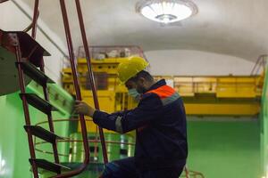 industrial worker with yellow helmet at the work photo