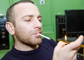 person smocking a cigarette photo