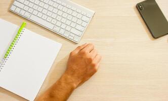 close up of hands typing on a laptop in office photo