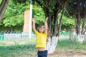 happy little boy playing in the park, long hair boy in the park photo