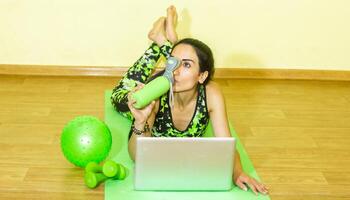 woman doing fitness exercise, young woman doing fitness exercises in fitness club photo