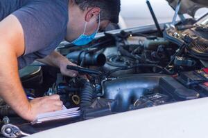 car mechanic fixing car engine, auto mechanic is repairing car engine photo