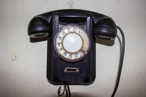 old black telephone, old fashioned telephone, old black fashioned telephone on white background photo