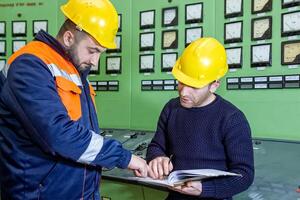 industrial workers at the work in factory photo