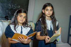 students in classroom doing homework photo