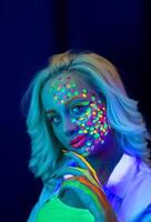 portrait of a woman with painted face, woman with uv makeup in studio, portrait of a woman in carnival mask, the woman is decorated in a ultraviolet powder photo