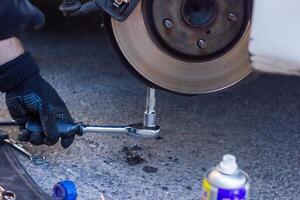 mechanic changing car wheel, car mechanic changing the wheel of a car photo