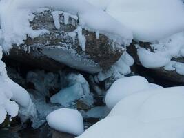 a rock covered in snow photo