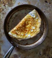 AI generated A photo of a pan with an omelette cooking, traditional mexican food pic