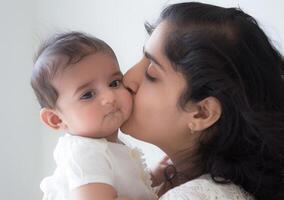 AI generated Mother kissing her baby against white backdrop, world kissing day idea photo