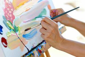 AI generated Woman hand paints brush easel, world art day design photo