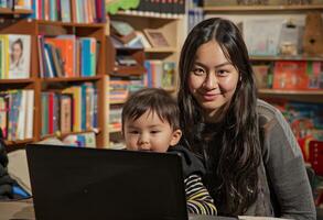 AI generated Woman and child sitting in front of laptop, labour day picture photo