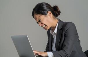 AI generated A woman in a suit typing on laptop expressing pain on her face on white background, labour day photo