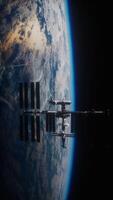 International space station on orbit of Earth planet view from space, vertical video