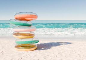 Stack of Colorful Swim Rings on Sunny Beach Shoreline photo