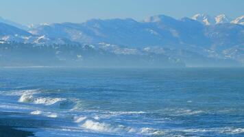 Sea Surf On A Deserted Pebble Beach. Mountains Are In Background. Real time. video