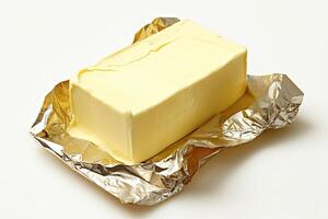 AI generated Golden butter in luxurious foil packaging isolated on white background. created with Generative AI photo