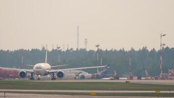 MOSCOW, RUSSIAN FEDERATION - JULY 29, 2021. Boeing 777 of Aeroflot taxiing at Sheremetyevo Airport, front view. Widebody aircraft on the runway video