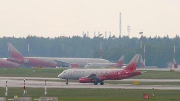 MOSCOW, RUSSIAN FEDERATION - JULY 30, 2021. Sukhoi Superjet, RA-89043 of Rossiya airplane on the taxiway at Sheremetyevo airport. Tourism travel concept video