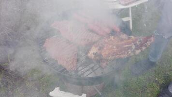 The pork chops are almost ready, the sausages must be turned to brown them well video