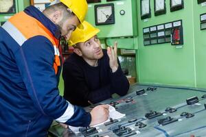 industrial workers at the work in factory photo