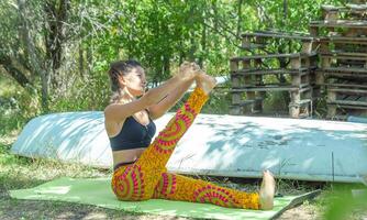 perrson doing yoga exercise on the beach, person relaxing on the beach, personn doing yoga photo