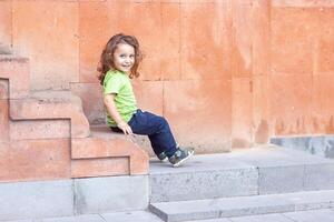 happy little boy playing in the park, long hair boy in the park photo