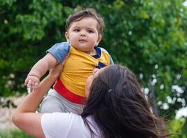 mother and baby boy in the garden photo